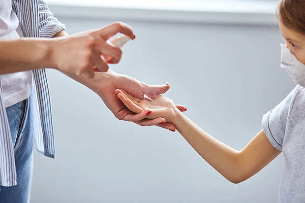 Mother And Daughter Using Wash Hand Sanitizer Gel 2ejqfur